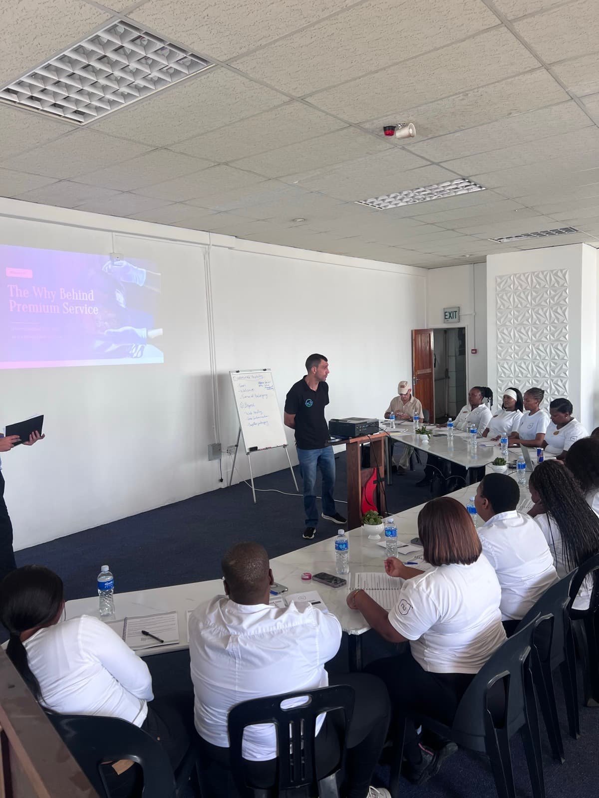 HirePro trainer presenting a service module to a hospitality team on site