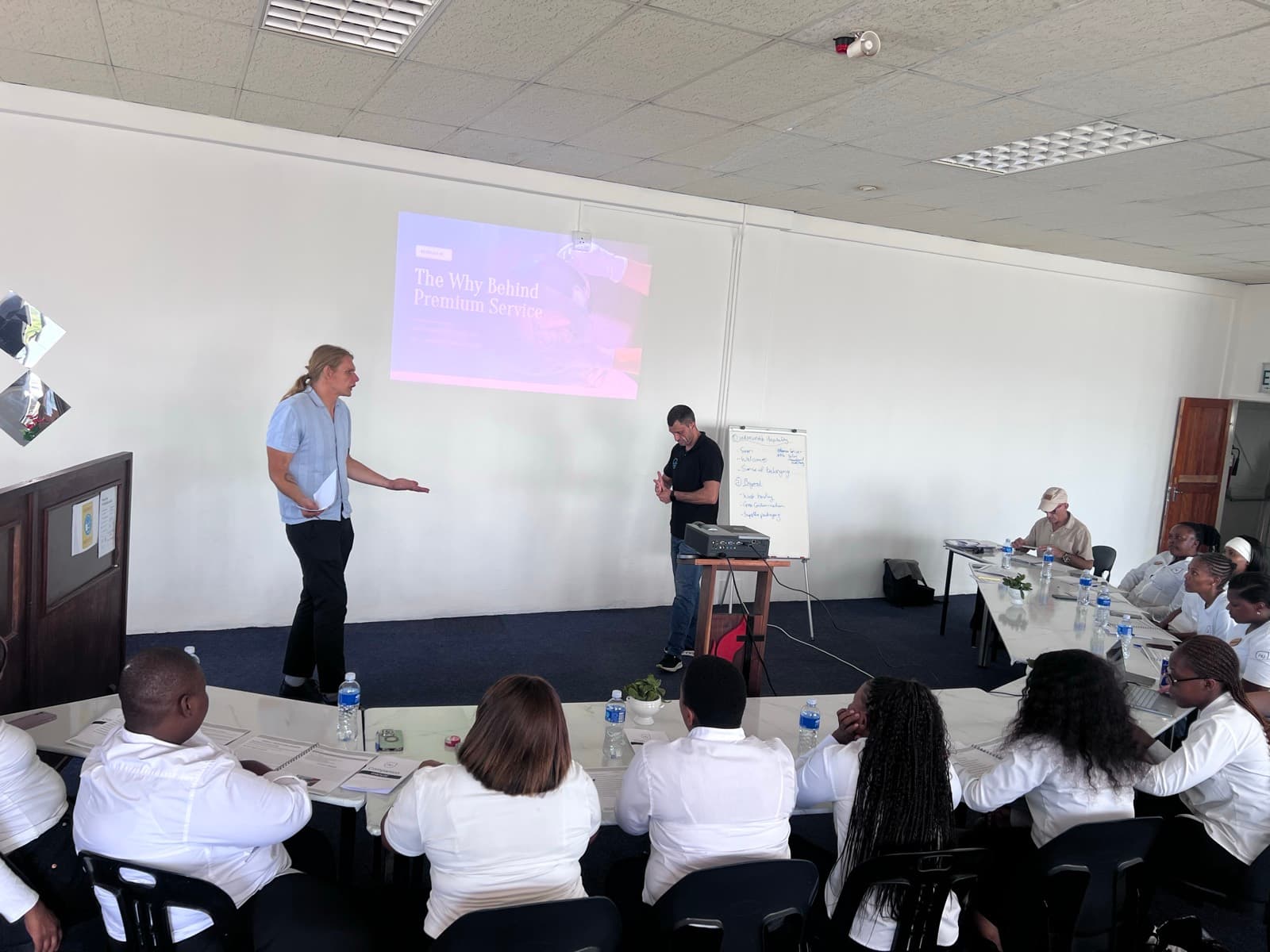 Two HirePro facilitators running a customer service course for a hospitality team